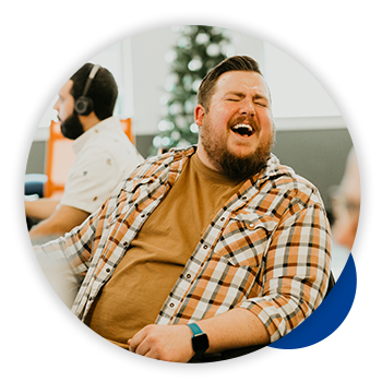 Quantum Workplace employee laughing at desk